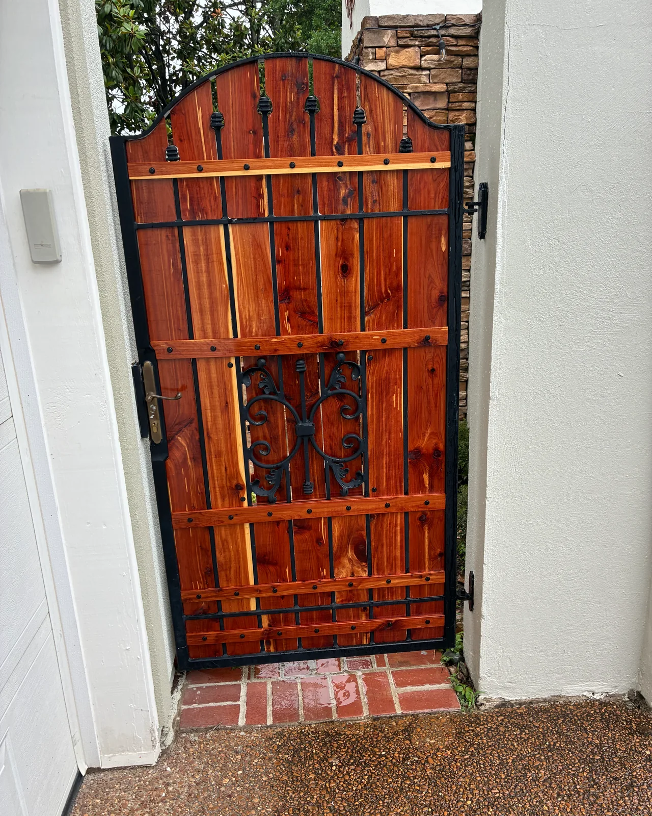 Cedar and black steel custom gate with decorative ironwork