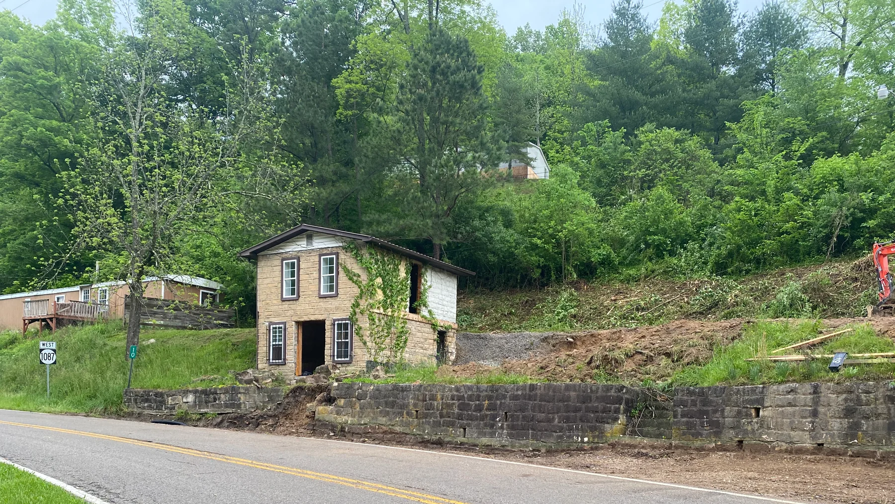 Existing residential structure and hillside excavation in progress